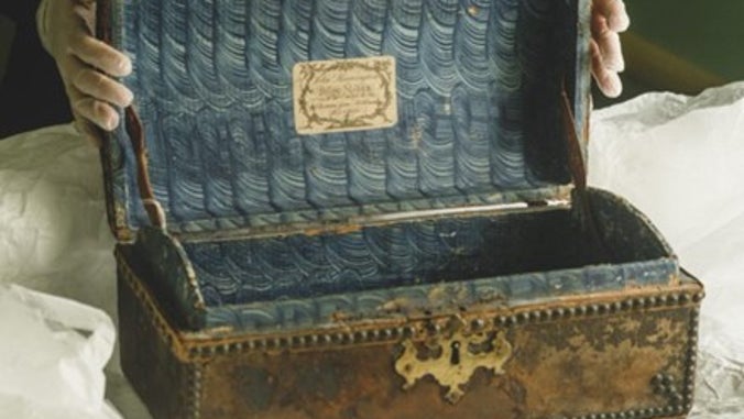 A small 18th century travel case, open to reveal the paper-lined interior and makers label, A la Ronde, Devon.